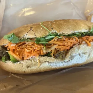 Large vegetarian tofu banh mi ($10.75). Baguette, curry tofu, pickled carrot and radish, cilantro, jalapeño, and garlic mayo.