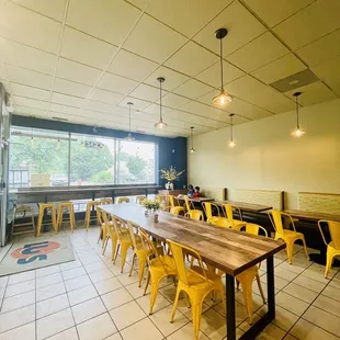 a long table with yellow chairs