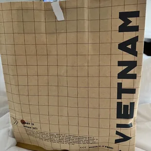 a shopping bag with a tv in the background
