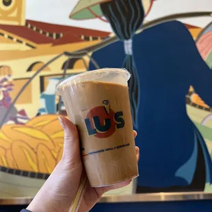 a hand holding a cup of coffee