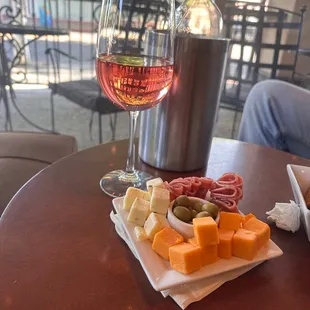 Meat and cheese tray with bottle of wine