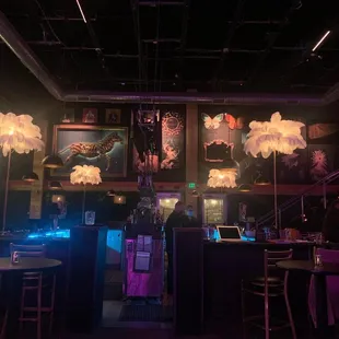 a dimly lit bar with purple lighting