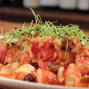 a dish of shrimp and tomato sauce