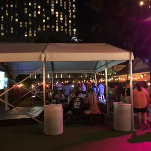 a group of people standing under a tent