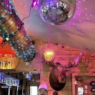 a man standing in front of a disco ball