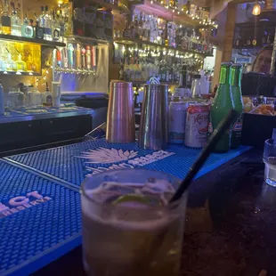 a drink in a tall glass on a bar