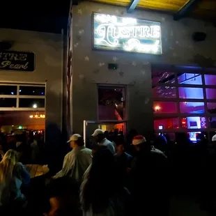 a crowd of people outside of a restaurant