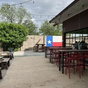 a patio with tables and chairs