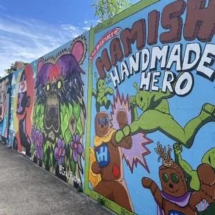 a colorful wall with cartoon characters painted on it