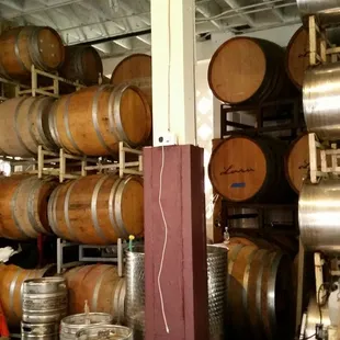 a woman standing in front of barrels