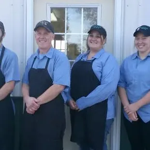 a group of people standing outside of a restaurant