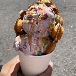 a person holding a cup of ice cream