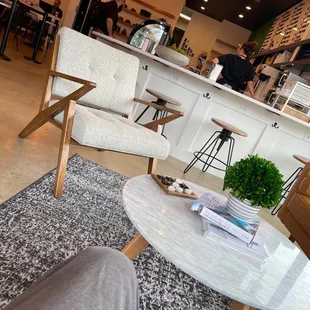 One of the many seating areas, bar, and view of the staff.