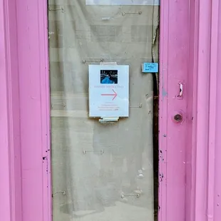 Door with sign that has hours when open