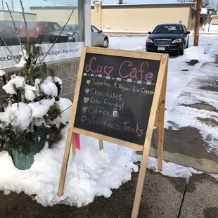 a sign outside of a cafe