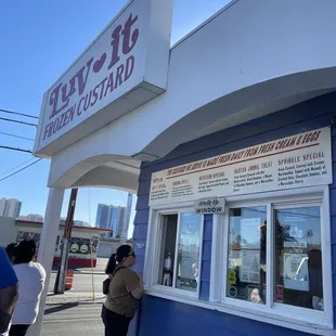 people standing outside of a store