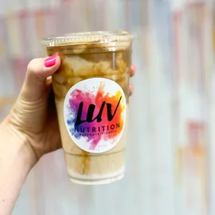 a hand holding a cup of coffee