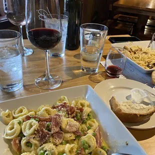 Cheese Tortellini Carbonara and a glass of Reserve Cabernet. Upper right is the Blackened Chicken Alfredo.