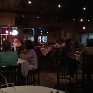 people sitting at tables in a restaurant