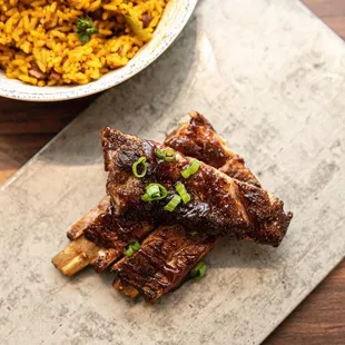 a plate of ribs and rice