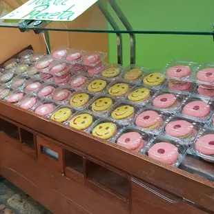 a display of doughnuts with smiley faces