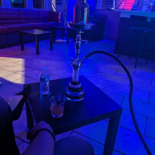 a glass of water and a hookah on a table