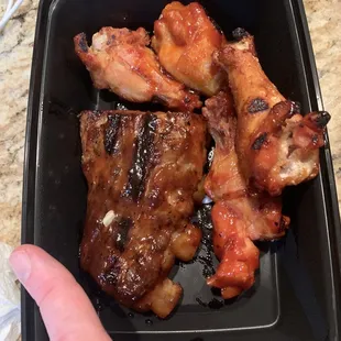 $17 worth of ribs &amp; wings! The saddest plate of ribs/wings that has ever existed. Included my finger as a size reference :(