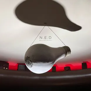 a lightbulb being suspended from a ceiling