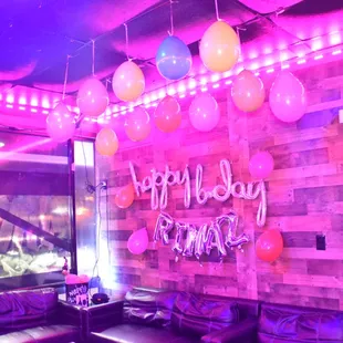 a neon sign and balloons