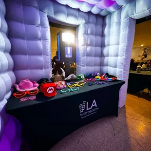 interior of black and white enclosed photobooth with props
