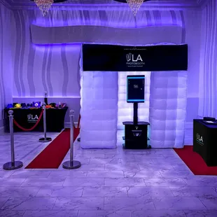 Luxury Package including white inflatable, props, scrapbook station, red carpet and stanchions.