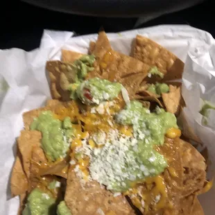 Barely 3 tbsps of guac for nachos with guac &amp; cheese Over cooked / burnt chips