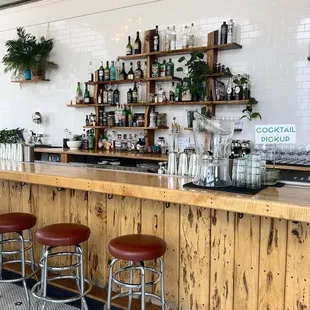 a bar with stools and shelves