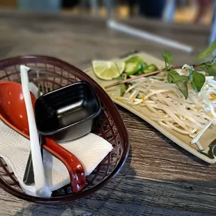a plate of noodles and a bowl of dipping sauce