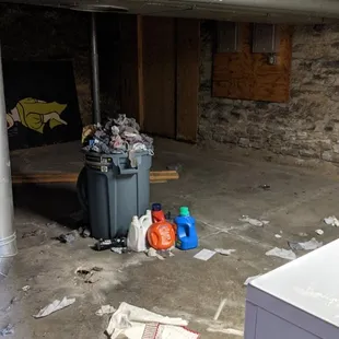 Dirty laundry dungeon with trash overflowing