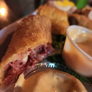 a roast beef sandwich with a side of gravy