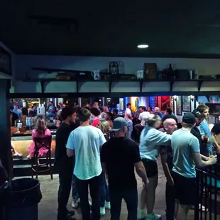a crowd of people at a bar