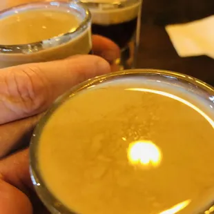 a person holding a glass of beer