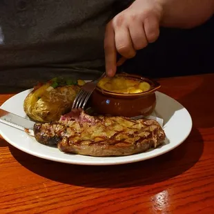 Ribeye with baked potato and Mac and cheese