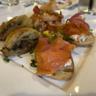 Salmon on bread, mushroom pastry and some other appetizers