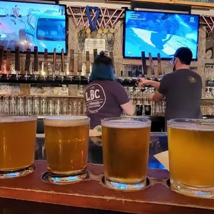 a row of beer glasses on a bar