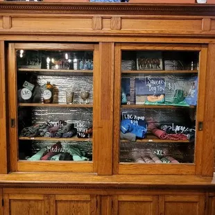 a wooden cabinet with glass doors