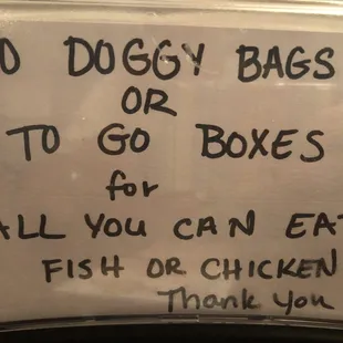 a sign stating to go boxes for all you can eat fish or chicken thank you