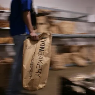 a man carrying a bag of bread