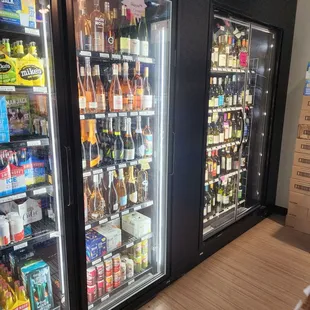 two refrigerators filled with drinks