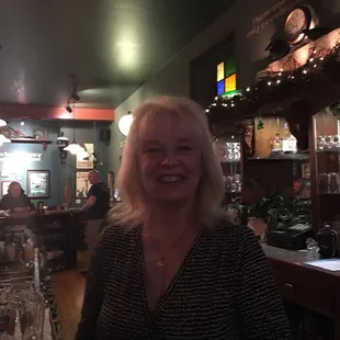 a woman smiling in a bar