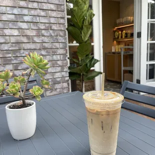 a cold beverage on a table outside