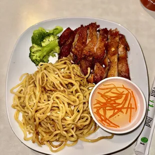 a plate of noodles and meat