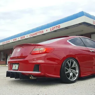 the rear end of a red honda accord