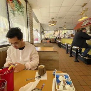a man sitting at a table in a restaurant